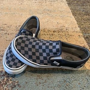 Gray and black checkered slip on vans